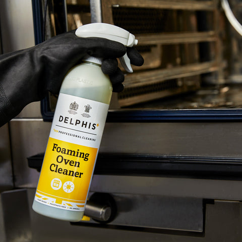 spraying the foaming oven cleaner