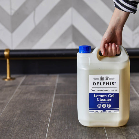 Person pIcking up the Delphis Eco 5 Litre Lemon Gel Cleaner from the floor