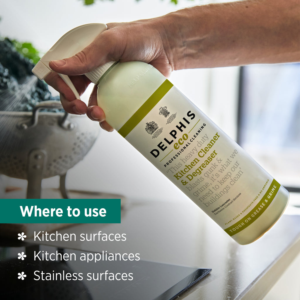 Bottle of Delphis Eco kitchen cleaner being held over a kitchen surface with text indicating where to use it.